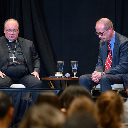 Archbishop Scicluna and moderator John Allen pray the Lord's Prayer with the audience following the discussion (Photo by Matt Cashore/University of Notre Dame)